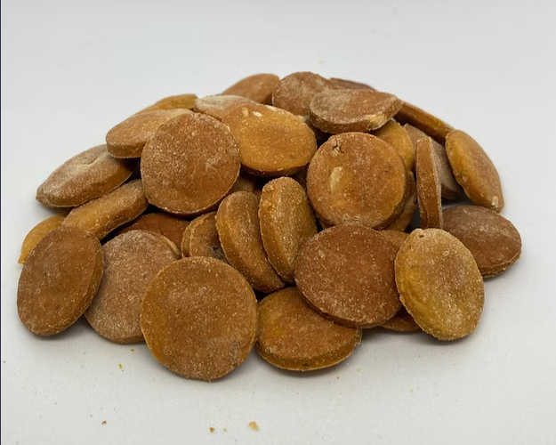 Brown round dog treats on a white background