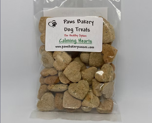 Bag of heart-shaped dog treats with a 'Paws Bakery' label on a white background