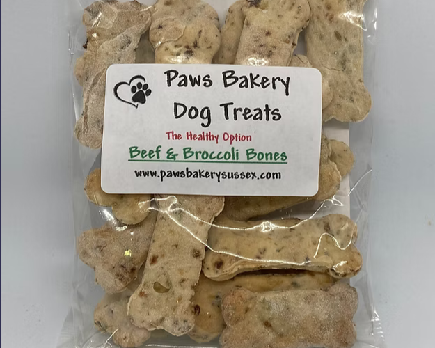 Packaged dog treats labeled 'Paws Bakery Dog Treats' on a white background
