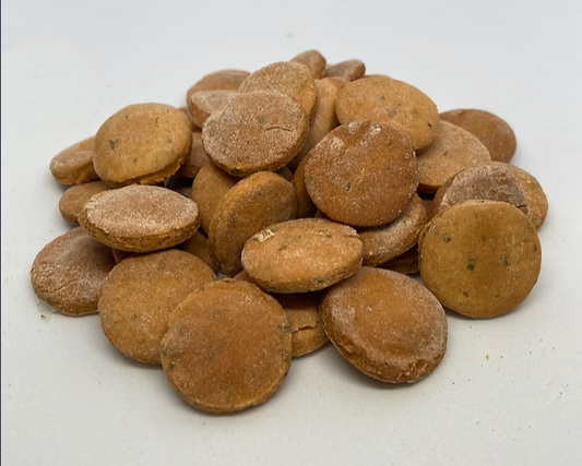 Stack of brown dog treats on a white background