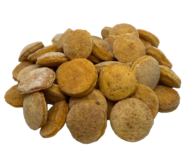 Pile of round, brown dog treats on a white background