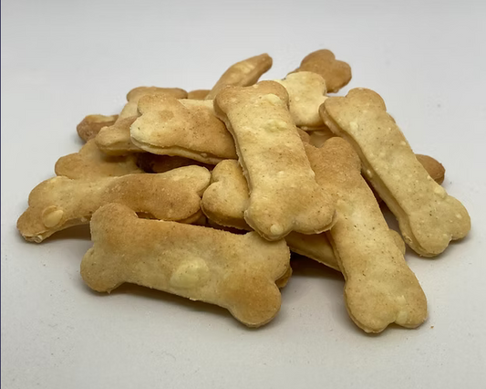 Stack of bone-shaped dog biscuits on a white background