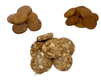 Two piles of dog treats on a white surface